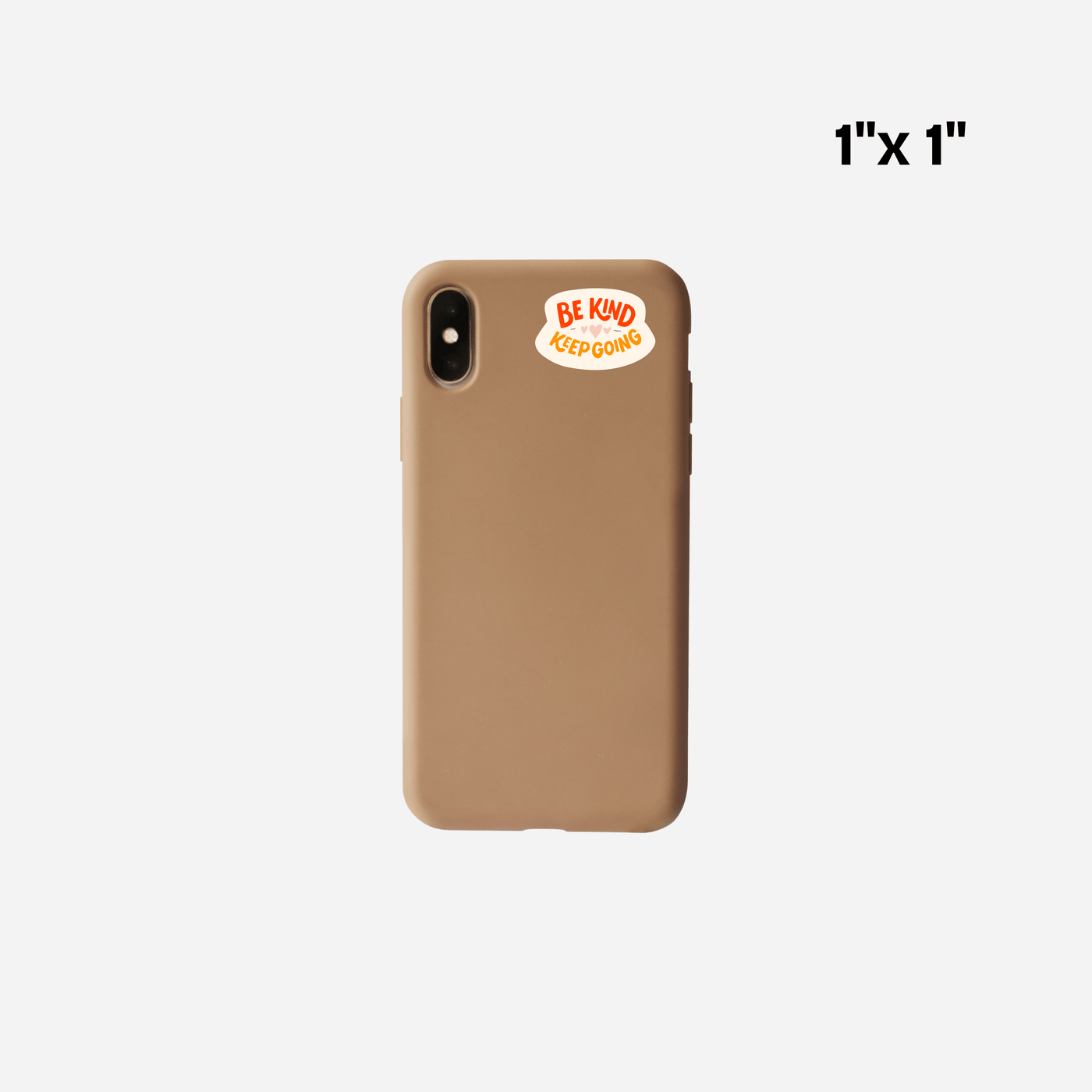 Small 'Be Kind Keep Going' UV DTF transfer sticker on brown phone case, 1x1 inch size