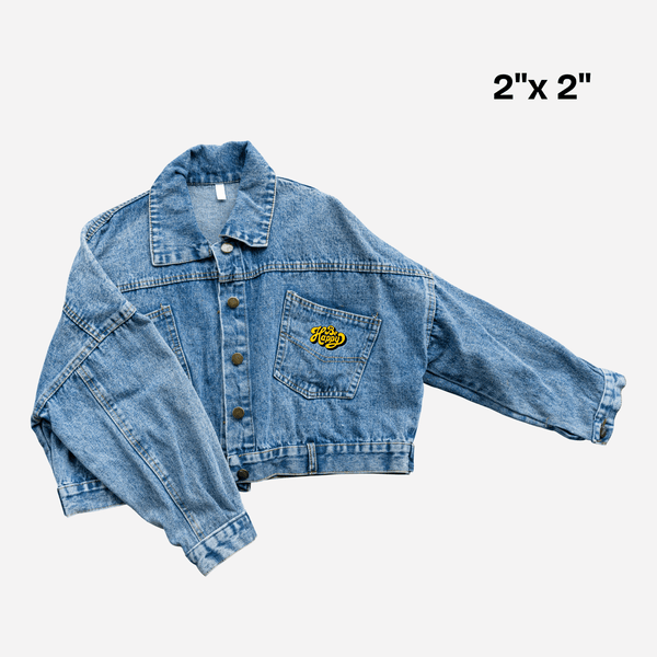 Denim jacket with small 2x2 inch custom DTF transfer design on pocket